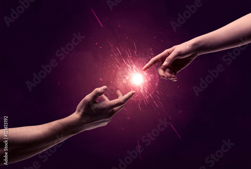 Touching hands light up sparkle in space