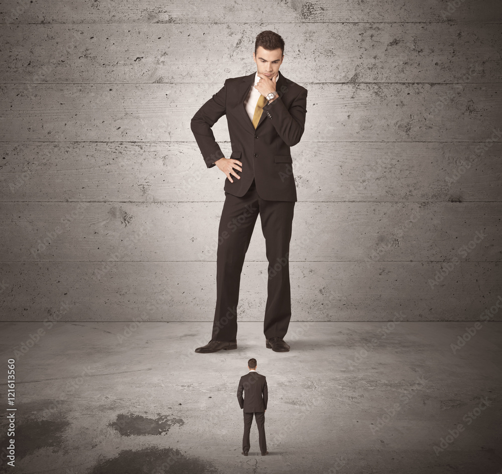 Obraz premium Huge business guy looking at small coworker