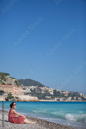 A women sitting and relaxing on the beach in Nice