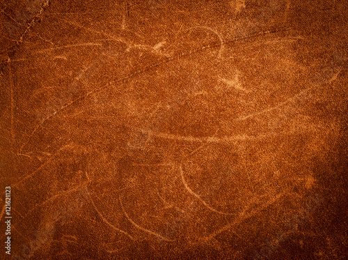 Rustic leather texture.Vintage brown leather background.Rough leather of a riders shoulder bag.