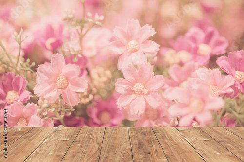 wood floor with pink sweet flower background.