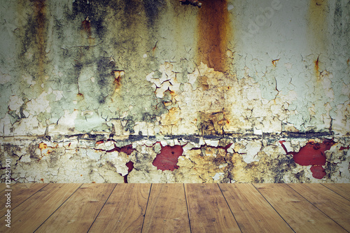 wood floor with rusty steel wall background.
