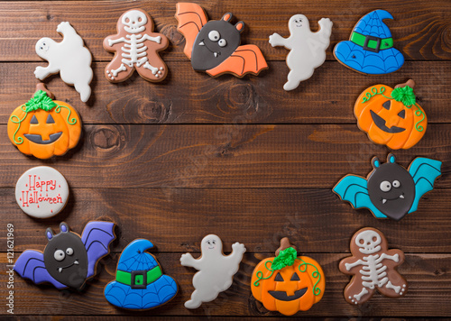 Funny delicious ginger biscuits for Halloween on the old wooden table.