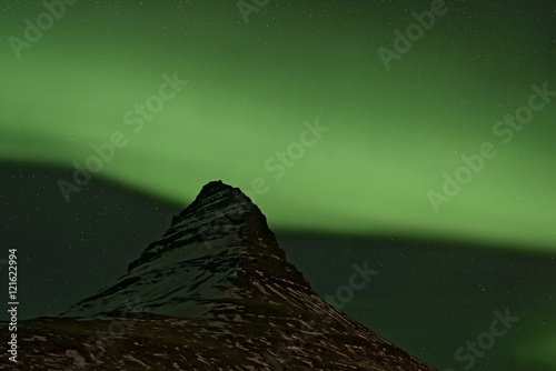 Aurora Borealis swirling around Kirkjufell, Iceland photo