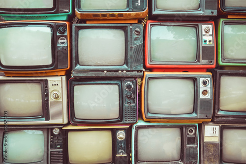 Pattern wall of pile colorful retro television (TV) - vintage filter effect style. photo