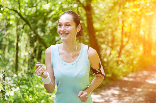 Young attractive woman running in the forest