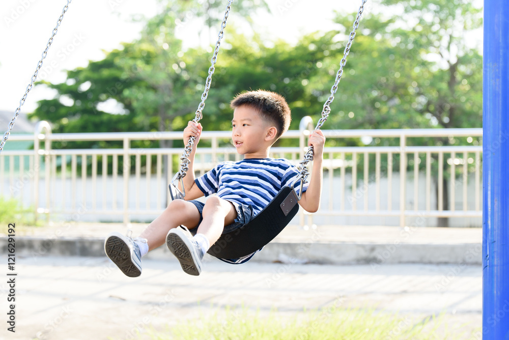 Asian boy play with swinging. with swinging.