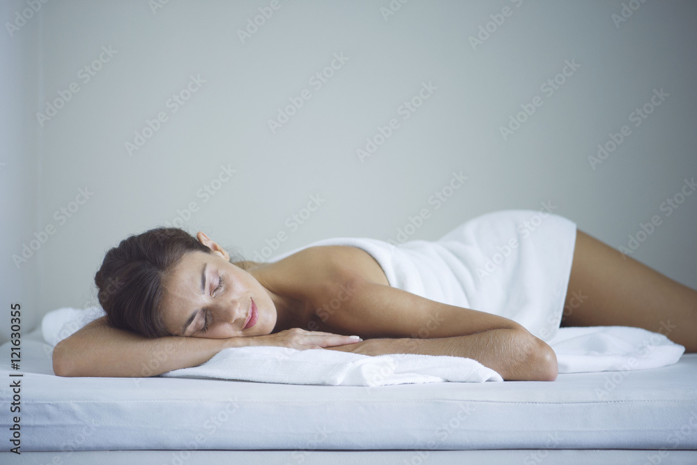 Woman napping at spa after beauty treatment Woman napping at spa after beauty treatment