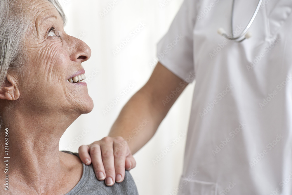 Woman being comforted by healthcare professional, cropped Woman being comforted by healthcare professional, cropped