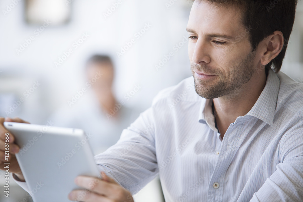 Mid-adult man using digital tablet Mid-adult man using digital tablet