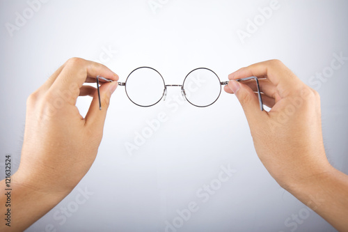 hand holding circle glasses