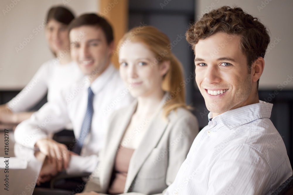 Young business professionals seated in conference room Young business professionals seated in conference room