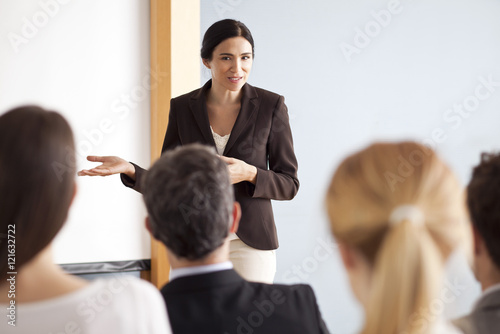 Businesswoman giving presentation at meeting