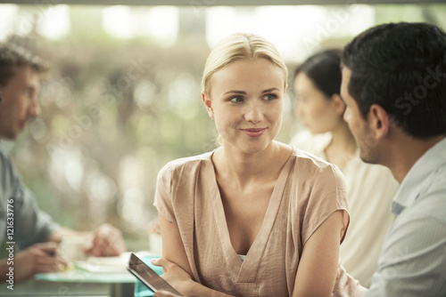 Woman smiling at male colleague during casual meeting