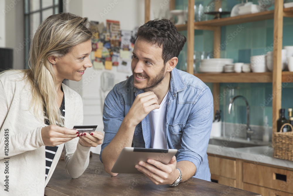 Couple using digital tablet to shop online at home Couple using digital tablet to shop online at home