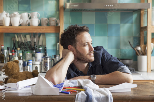 Man daydreaming in kitchen