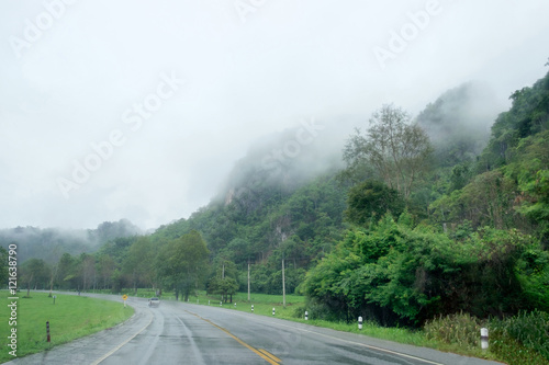 Mountain fog rainy season on rural road