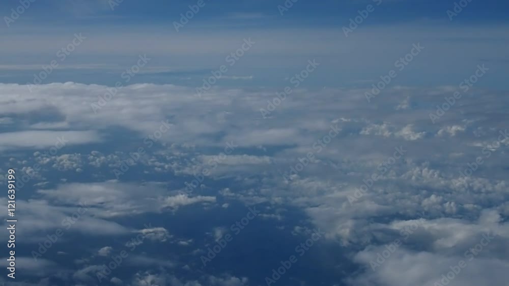 Blue sky and white clouds. Beautiful cloudscape moving clouds in blue sky view from airplane. Blue sky and white clouds. Beautiful cloudscape moving clouds in blue sky view from airplane.