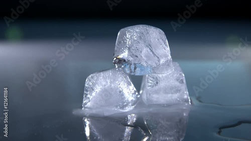 Three ice cubes melting fast