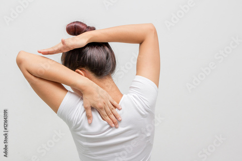 Back view portrait of a young woman stretching hands on white background