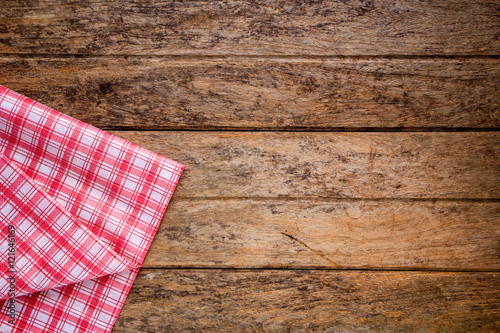 Red checkered napkin on a wooden table.