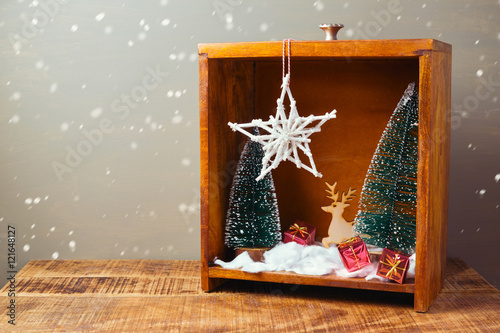 Photography Christmas diorama with pine trees and decorations on wooden table