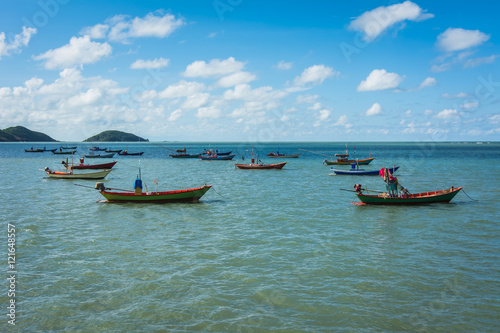 Fishing boats in the sea and a beautiful sky at The Chao Lao Beach, Chanthaburi, Thailand.