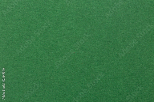 Textured dark green paper as background.