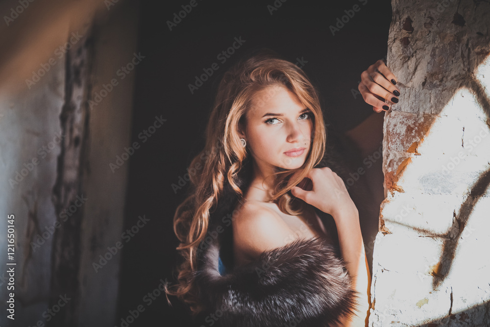 Young beautiful girl in vintage romantic antique dress near the vintage wooden door. fairy tale, legend