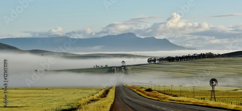 Landscape with quiet Country Road and morning fog photo