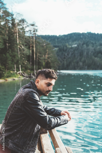 Man thinking on pier by a l...