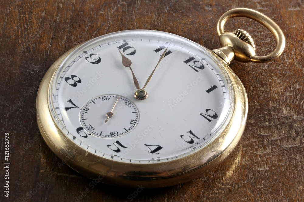 schweizer Taschenuhr aus 585 Gold auf Holztisch schweizer Taschenuhr aus 585 Gold auf Holztisch