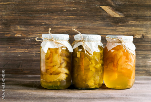Jam of pears and apples in glass jars on a blue wooden background