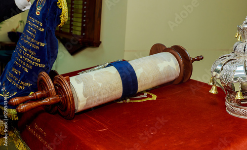 Hand of boy reading the Jewish Torah at Bar Mitzvah photo