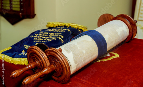 Hand of boy reading the Jewish Torah at Bar Mitzvah photo