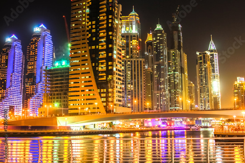 Bridge of Dubai Marina District by night. Dubai Marina is a modern district that allows Dubai to place themselves in fourth place in the ranking of cities in the world with most skyscrapers.