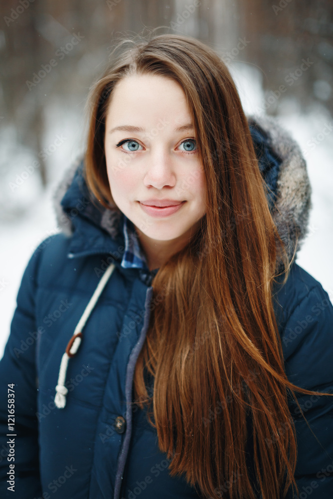 Beautiful woman in winter clothes standing in winter par Beautiful woman in winter clothes standing in winter par