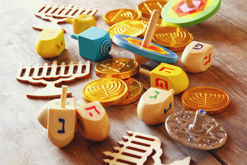jewish holiday Hanukkah with dreidels (spinning top) and coins 
