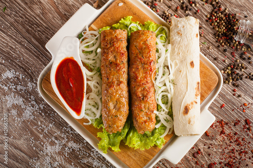 lula kebab on a wooden board  photo