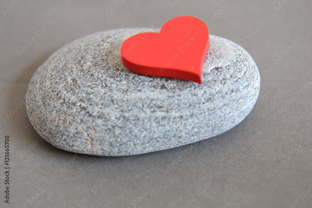 Fototapeta premium Love. Red heart on the stone background. Gray background. Heart heaviness. Heart healthy. 