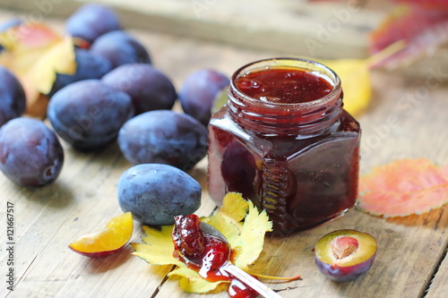 Sweet homemade plum jam and fresh autumn fruits