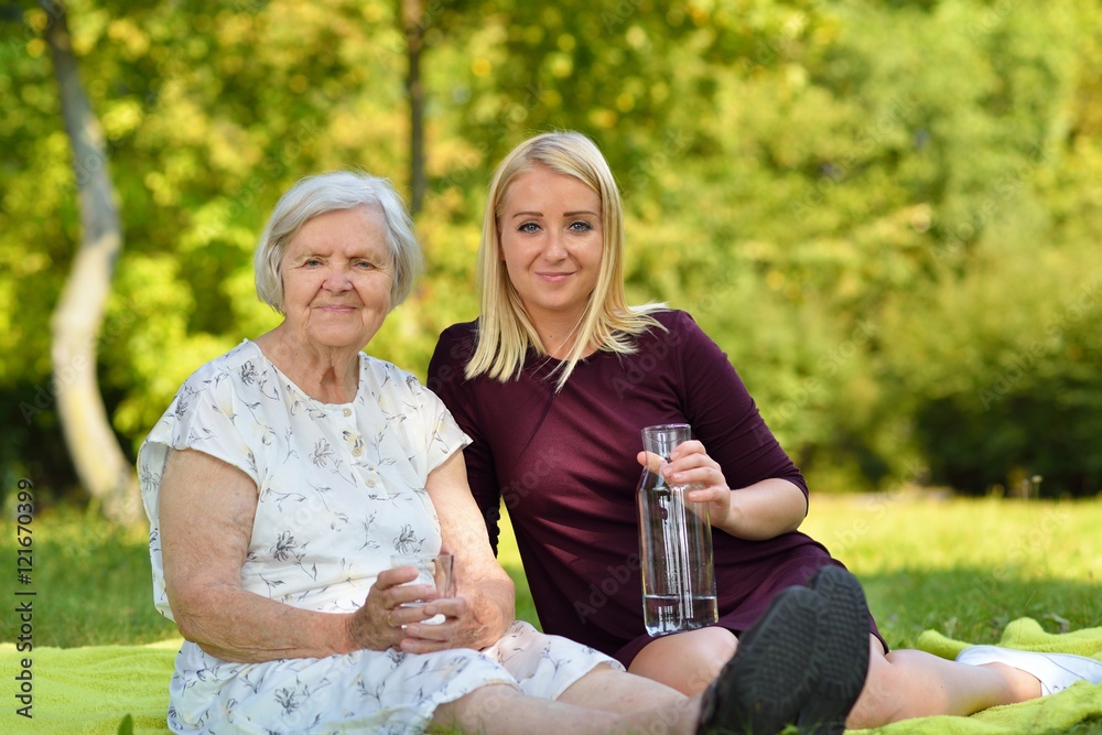 Elderly woman and young woman at the picnic.
