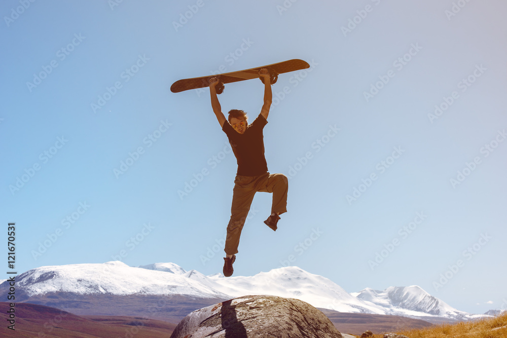 Snowboarder jumps on mountains backdrop skiing