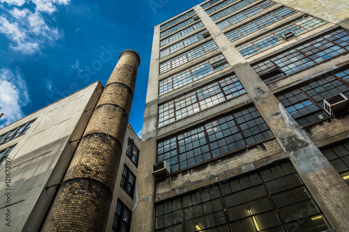 Принти на полотні Old office building with brick smokestack