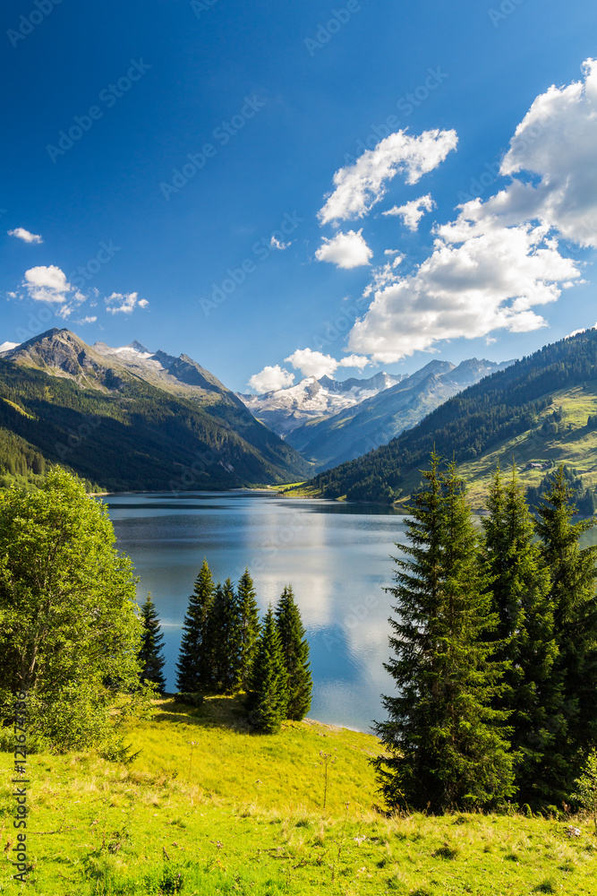 Naklejka premium Colorful summer morning on the Speicher Durlassboden lake. View of Richterspitze mountain range in the Austrian Alps. Austria, Europe.