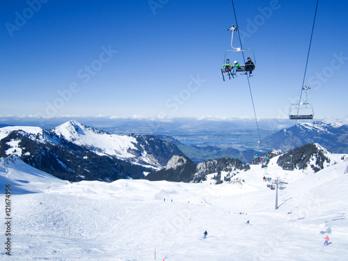 Skiers skiing in Klewenalp ski resort in Swiss Alps near Lucerne, Central Switzerland