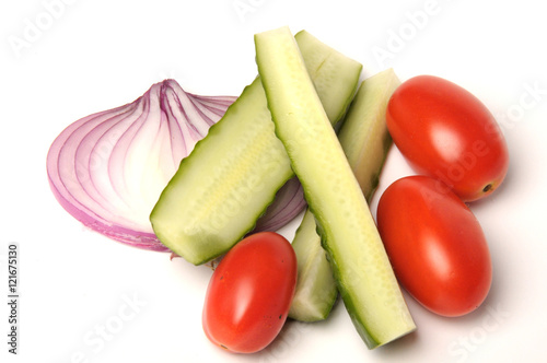 salted cucumber, red cherry tomatoes and sliced red onion on white, traditional snack while drinking vodka