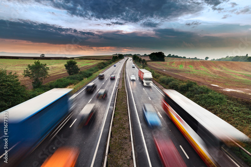 Blurred Shapes of Moving Vehicles on Busy Rural Motorway photo