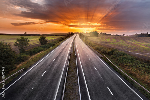 Sunset Sky over Empty Asphalt Road of Dual Carriage Motorway © Eddie Cloud