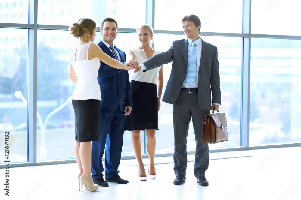 Business people group joining hands and representing concept of friendship and teamwork Business people group joining hands and representing concept of friendship and teamwork